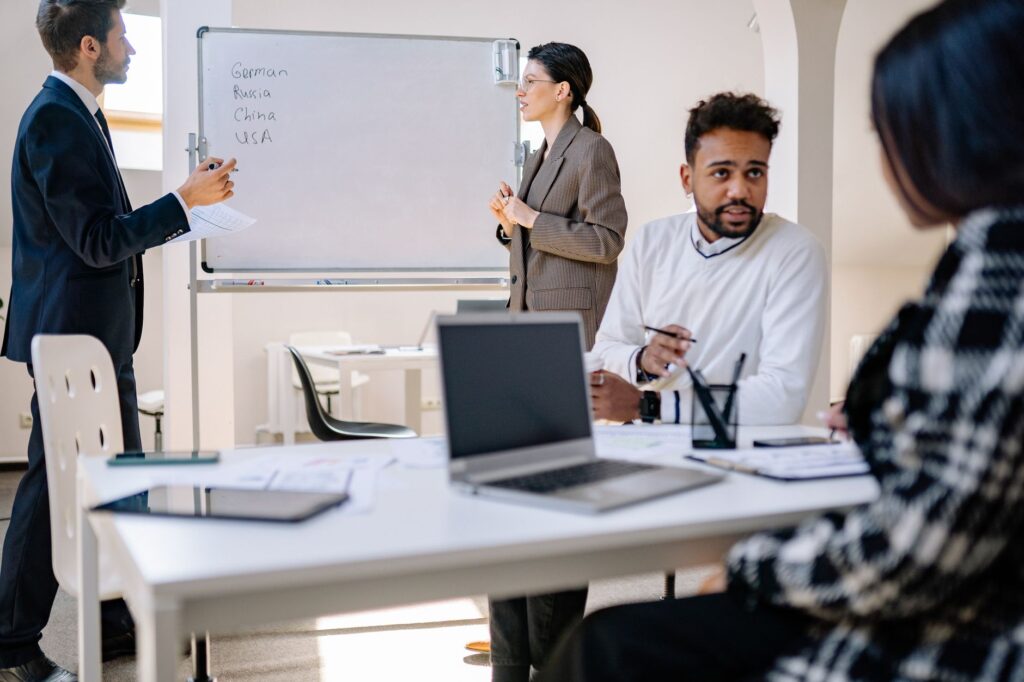Diverse business professionals engaged in a collaborative office meeting, representing a nearshore outsourcing team